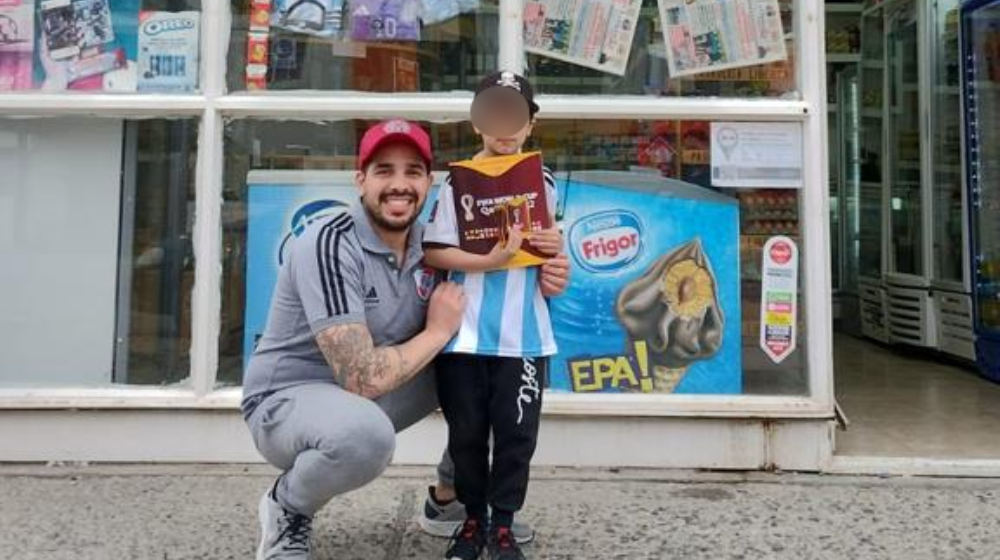 Martín, feliz con su álbum, junto al kiosquero Javier.