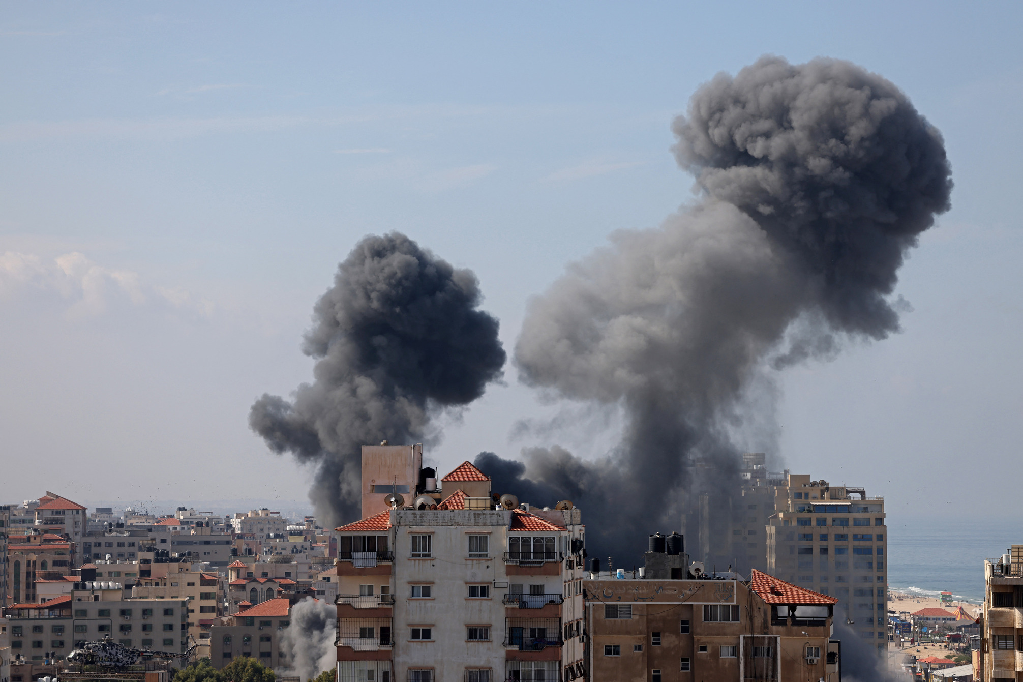 Smoke billows from a residential building following an Israeli airstrike in Gaza City on October 7, 2023. Barrages of rockets were fired at Israel from the Gaza Strip at dawn as militants from the blockaded Palestinian enclave infiltrated Israel, with at least one person killed, the army and medics said. (Photo by MOHAMMED ABED / AFP)